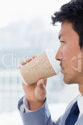 Portrait of an office worker drinking a takeaway coffee
