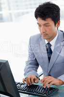 Portrait of a serious manager using a computer