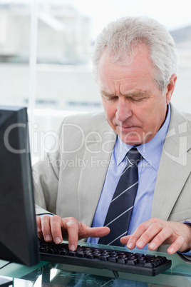 Portrait of a senior manager using a computer