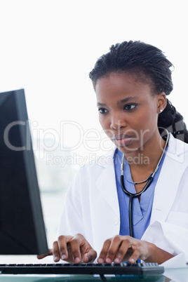 Portrait of a female doctor using a computer