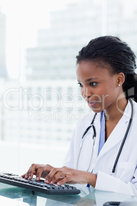Portrait of a serious female doctor using a computer
