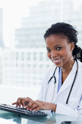 Portrait of a smiling female doctor using a computer