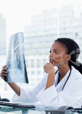 Portrait of a female doctor looking at a set of X-rays