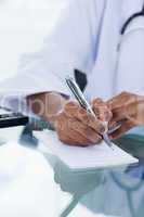 Portrait of a feminine hand writing a prescription