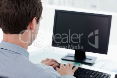 Back view of a businessman working with a computer