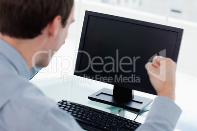 Back view of a businessman working with a computer with the fist
