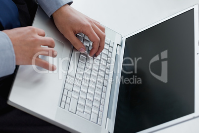 Angle view of hands typing