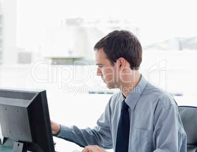 Serious office worker using a monitor