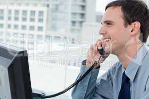 Smiling office worker on the phone