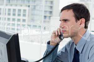 Serious office worker on the phone