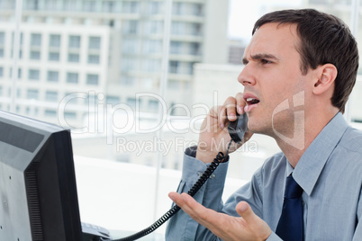 Confused office worker on the phone