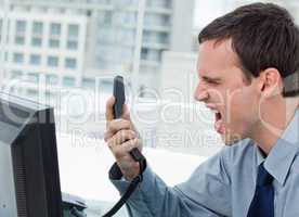 Angry office worker on the phone