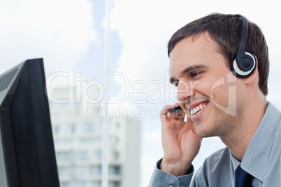 Smiling office worker using a headset