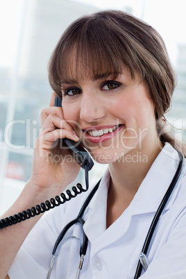 Portrait of a happy doctor on the phone