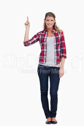 Portrait of a woman pointing at a copy space