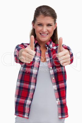 Portrait of a blissful woman with the thumbs up