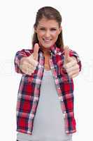 Portrait of a young woman with the thumbs up