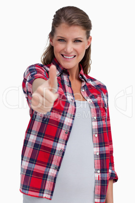 Portrait of a blissful woman with the thumb up