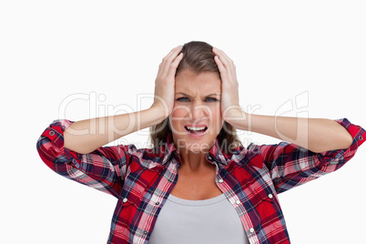 Irritated woman with the hands on her head