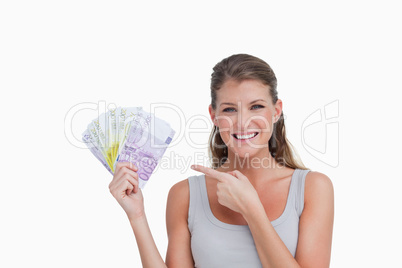 Woman pointing at bank notes