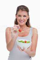 Portrait of a young woman eating a salad