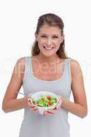 Portrait of a woman showing a salad