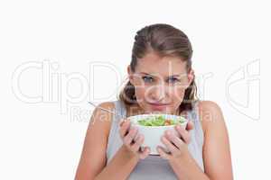 Quiet woman smelling a salad