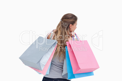 Back view of a woman holding shopping bags