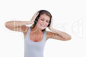 Happy woman dancing while listening to music