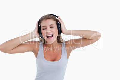 Happy woman singing while listening to music