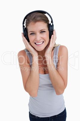 Portrait of a smiling woman listening to music