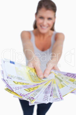 Portrait of a happy woman showing bank notes