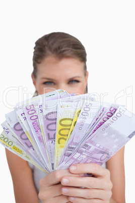 Portrait of a cute woman showing bank notes