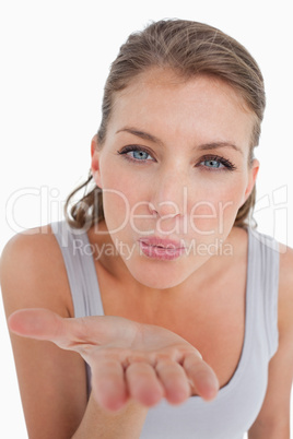 Portrait of a beautiful woman blowing a kiss