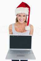 Woman with a Christmas hat showing a notebook