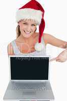 Woman with a Christmas hat pointing at a notebook