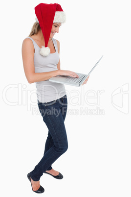 Portrait of a woman with a Christmas hat using a notebook