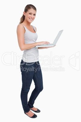 Portrait of a smiling woman using a laptop