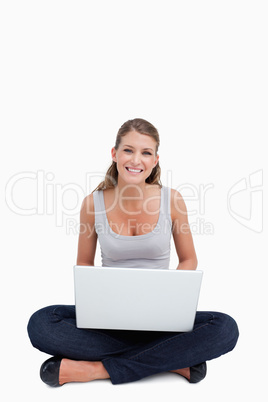 Cross-legged woman using a notebook