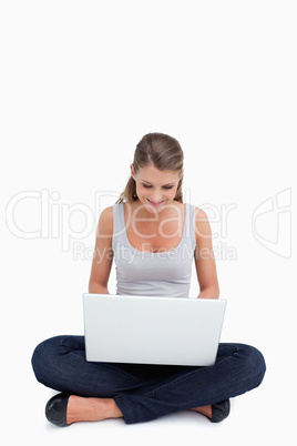 Cross-legged woman using a laptop