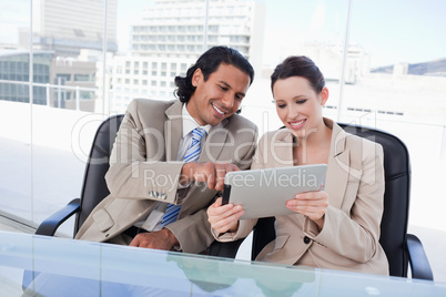 Happy business team using a tablet computer