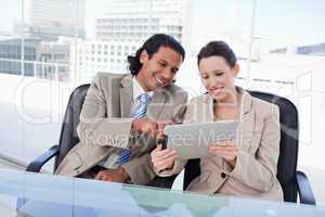 Happy business team using a tablet computer