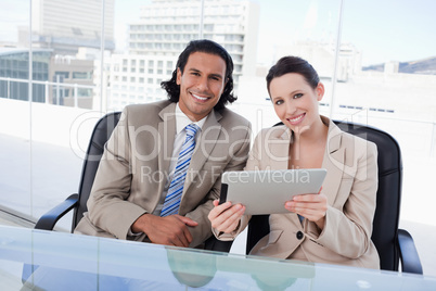 Cheerful business team using a tablet computer