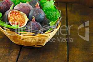 Basket of ripe figs in a basket on bed of leaves