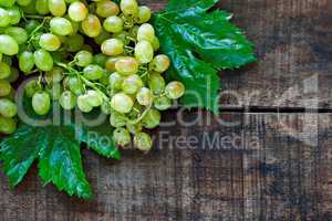 Green grapes on a rustic wooden table