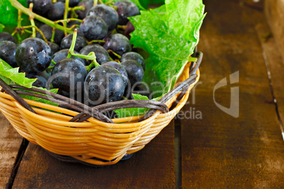 Basket of grapes on rustic wooden table