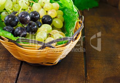 Basket of grapes on rustic wooden table