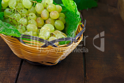 Basket of grapes on rustic wooden table