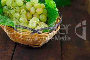 Basket of grapes on rustic wooden table