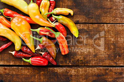 Assortment of chilli peppers on a rustic wooden table